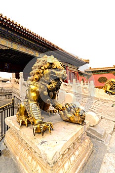 Copper lion in front of an ancient architecture