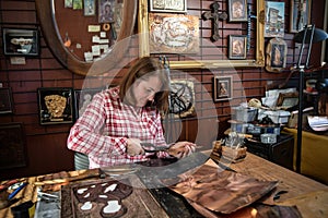 Copper master, hands detail of craftsman at work