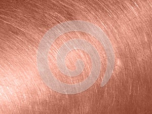 Copper metal texture with circular scratches.