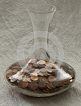 Copper money coins in glass vase