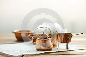 Copper old scratched vintage crockery kitchenware on the table