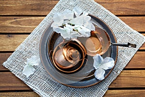 Copper old scratched vintage crockery kitchenware on the table