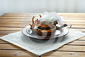 Copper old scratched vintage crockery kitchenware on the table