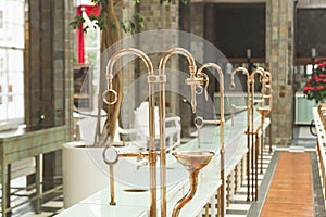 The copper pipes and faucets for mineral waters in the Fountain Hall of the Wandelhalle in Bad Kissingen, Germany