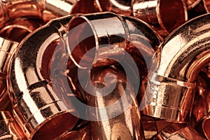 Copper pipes in a pile. Abstract background.