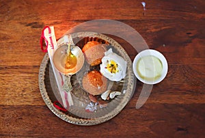 copper plat filled with rakhi and sweets on the occasion of Raksha Bandhan from top angle