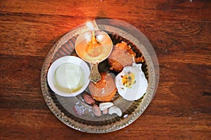 copper plat filled with rakhi and sweets on the occasion of Raksha Bandhan from top angle