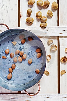 Copper pot with apricot pits photo