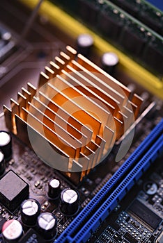 A copper radiator for cooling the chip on the computer board. Radio components.The computer's motherboard