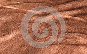 Copper-red creased material background.