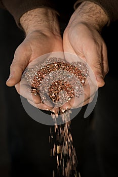 Copper shavings in the hands of the workers.