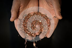 Copper shavings in the hands of the workers.