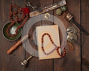 Copper singing bowl, prayer beads, prayer drum and other Tibetan religious objects for meditation