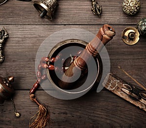 Copper singing bowl, prayer beads, prayer drum and other Tibetan religious objects for meditation