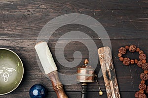 Copper singing bowl, prayer beads, prayer drum and other Tibetan religious objects for meditation and alternative medicine