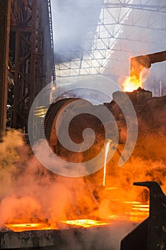 Copper smelter barrel pouring molten copper into the casts