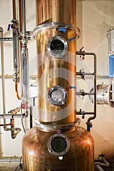 Copper still alembic inside distillery