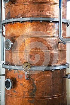 Copper still alembic inside distillery to distill grapes and produce spirits photo