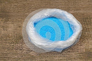 Copper Sulphate Crystals in a bag, Wooden background