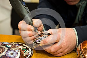 Coppersmiths carving in the bronze street of Sarajevo, Bosnia and Herzegovina