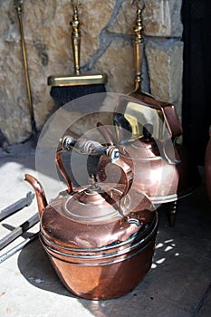 Copperware at an old fireplace
