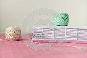 Coptic binding process. Book binding. Thread and pages. Copy space, close up, side view
