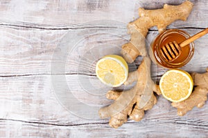 Copy free space. Healthy concept. Lemon, ginger, honey on a white wooden background. Flat lay. Treatment of cold and