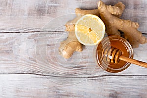 Copy free space. Healthy concept. Lemon, ginger, honey on a white wooden background. Flat lay. Treatment of cold and