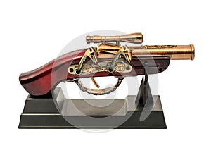 Copy of an old gun with wooden handle on a stand isolated on white background