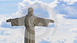 The copy of the sculpture of Christ the Savior spread his arms on blue sky background. Religion concept