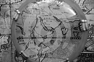 Antique map through nautical magnifying glass photo