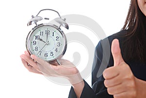 Copy space an alarm clock with woman hand showing succes sign