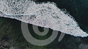 Copy space and background concept. Top down view of fantastic tropical sea tide on coastline. Drone shot of beautiful