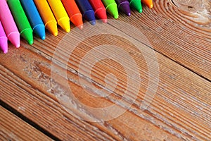 Copy space background with oil pastel crayons on a wooden table