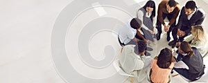 Copy space banner with overhead view of group of people sitting in circle and talking