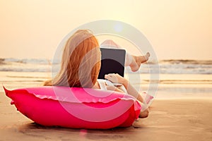 Copy space Beautiful young woman working with laptop on the tropical beach. Happy traveling female using laptop on