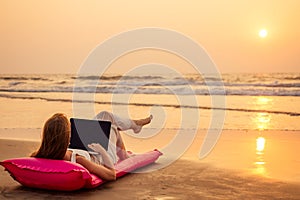 Copy space Beautiful young woman working with laptop on the tropical beach. Happy traveling female using laptop on