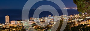 Copy space with dark night sky over the view of a coastal city seen from Signal Hill in Cape Town, South Africa. Calm