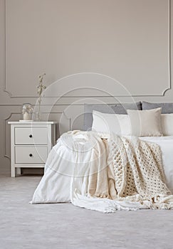 Copy space on empty grey wall of scandinavian bedroom interior