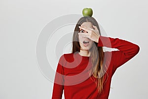 Copy space. Healthy lifestyle. Close up portrait of young beautiful caucasian girl with long hair in red jumper looking