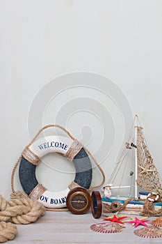 Copy space with lifebuoy, compass, boat, starfish and rope. Vacation on the sea.