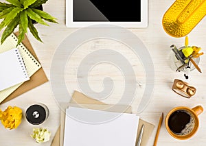 Copy space, paper, stationery and tablet computer on wooden background