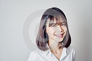 Copy space portrait of smiling asian young woman put on the braces.