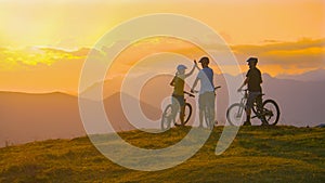 COPY SPACE: Three friends celebrate a cross country bike trip on a sunny evening