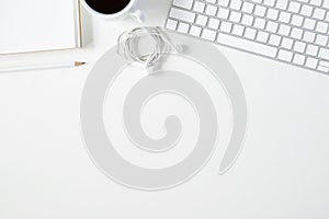 Copy space topview of white office stuff on white working table.