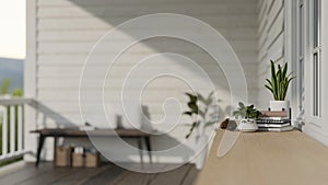 A copy space on a wooden tabletop with decor at a home patio or balcony