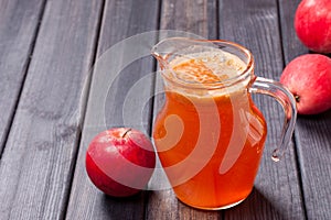 Copy spase photo of red apples and juice in the pitcher on table