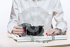 Copyright. The camera is chained to the photographer& x27;s hand. The concept of protecting the photographer from theft