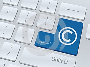 Copyright concept on button of white computer keyboard.