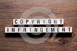Copyright infringement - word concept on building blocks, text